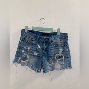 Lucky brand size 4 ripped up shorts with raw hem and paisley pocket